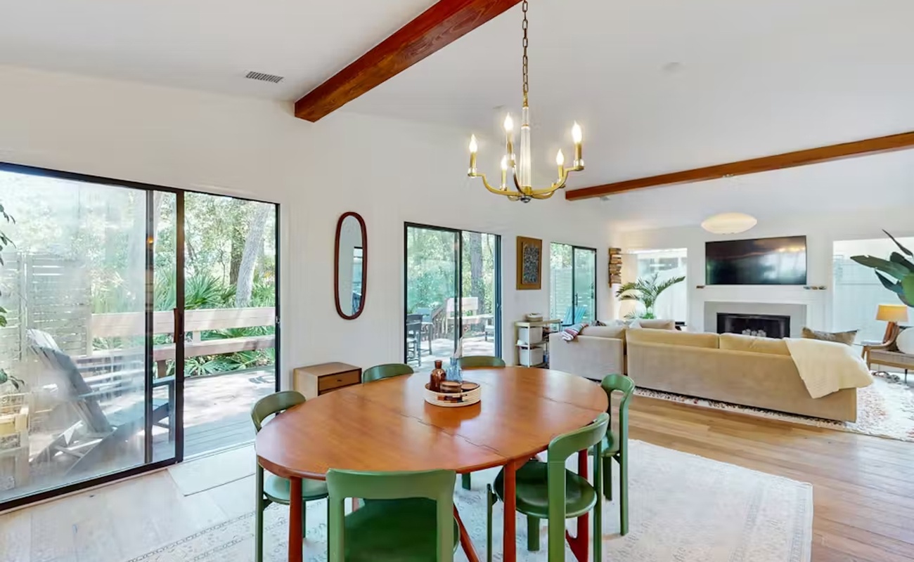 Gather around your elegant dining table while natural light streams through floor-to-ceiling windows, creating the perfect backdrop for memorable meals.