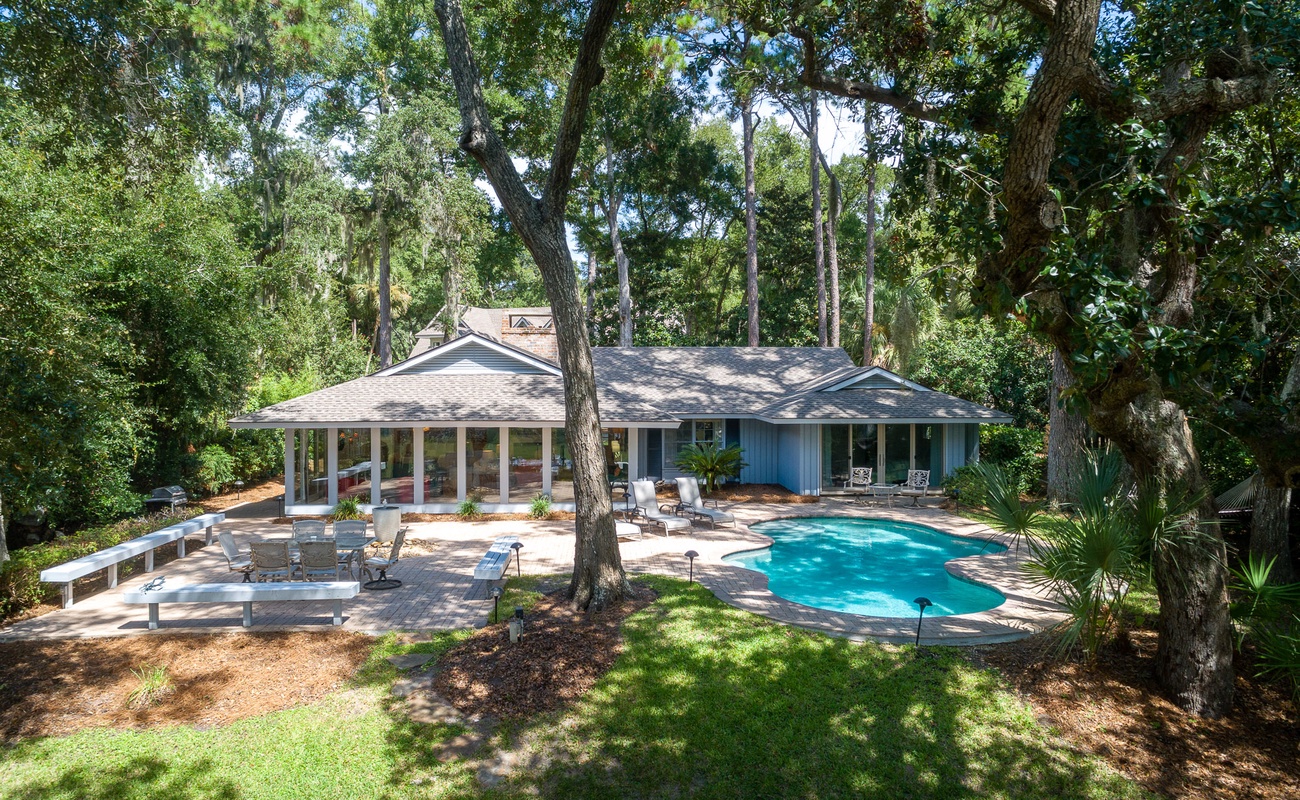 Charming retreat nestled among towering trees with private pool and spacious outdoor entertaining areas.