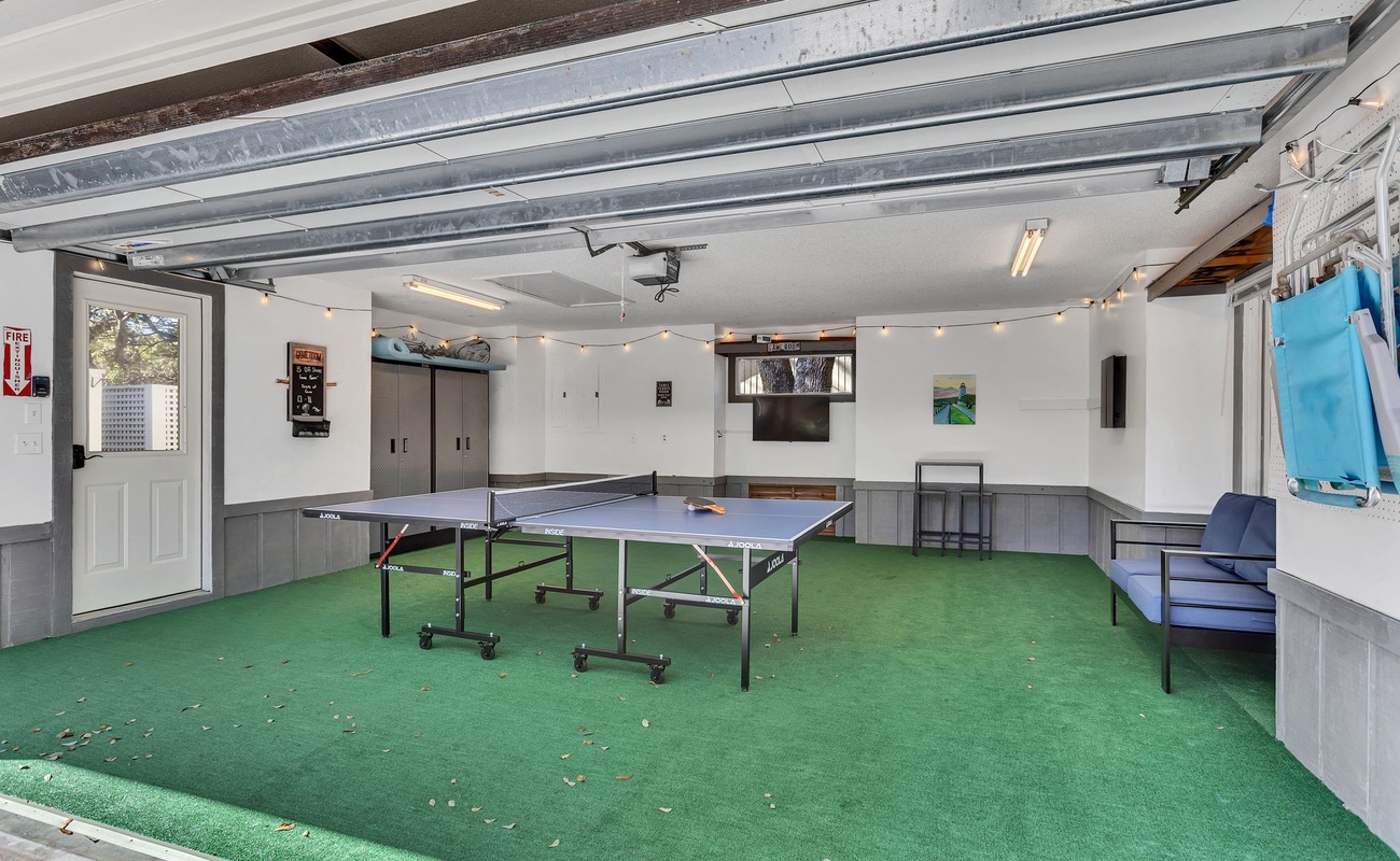 Your private game room features ping pong, cozy seating, and string lights creating the perfect atmosphere for friendly competition and relaxation.