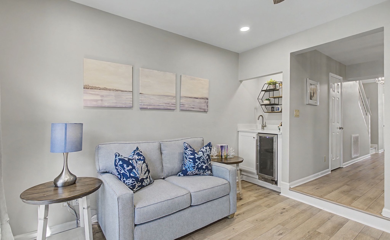 Sink into this cozy seating area where coastal charm meets modern comfort—your perfect spot to unwind after exploring.