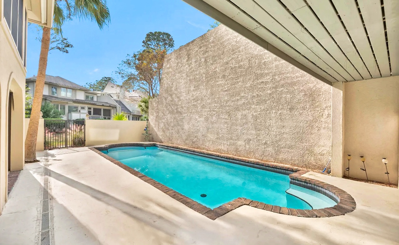 Your private oasis awaits with crystal-clear waters and covered lounging space perfect for sunny afternoons and evening relaxation.