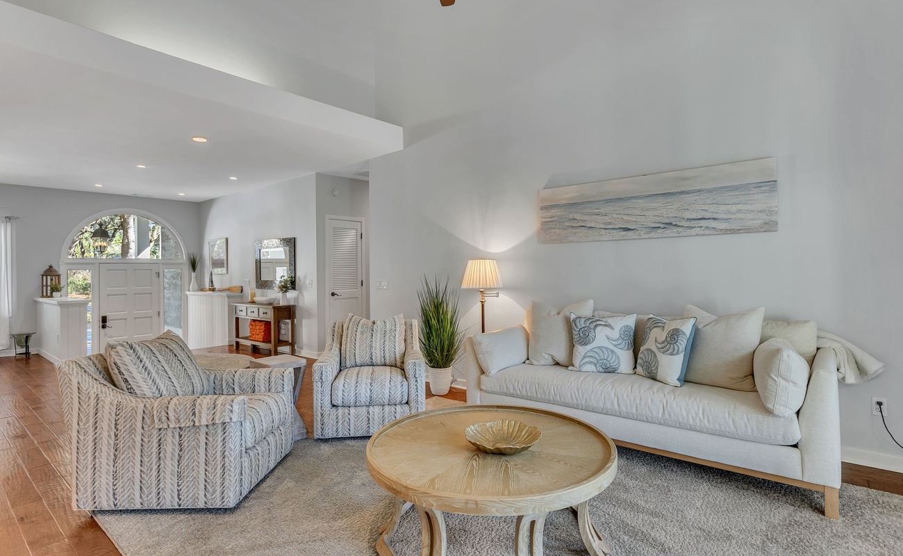 Sink into plush coastal sofas in this bright living room, where ocean-inspired decor and natural light create your perfect retreat.