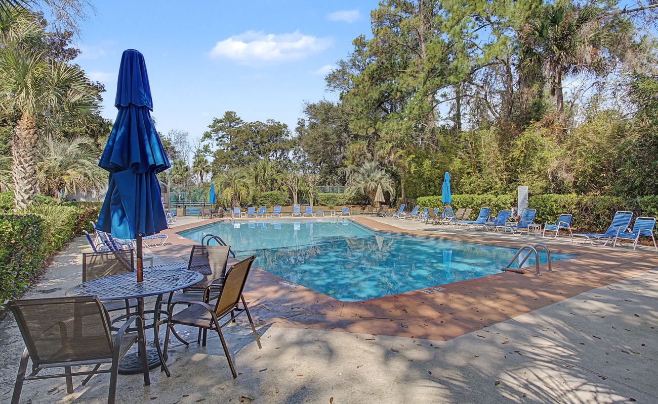 Sparkling pool surrounded by lush tropical gardens and comfortable loungers where you can relax under swaying palms.