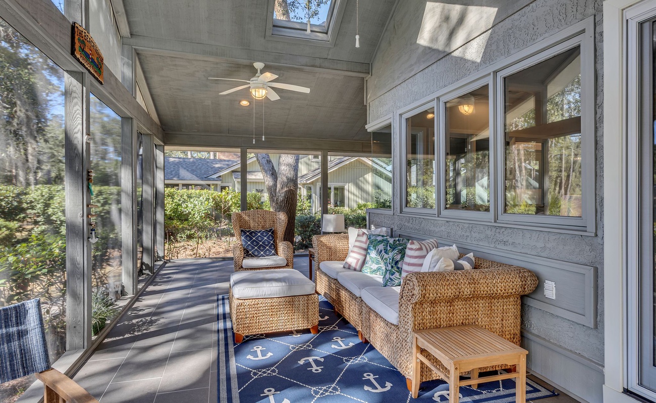 Relax in your screened porch with wicker seating, where natural light streams through skylights and gentle breezes flow through open windows.