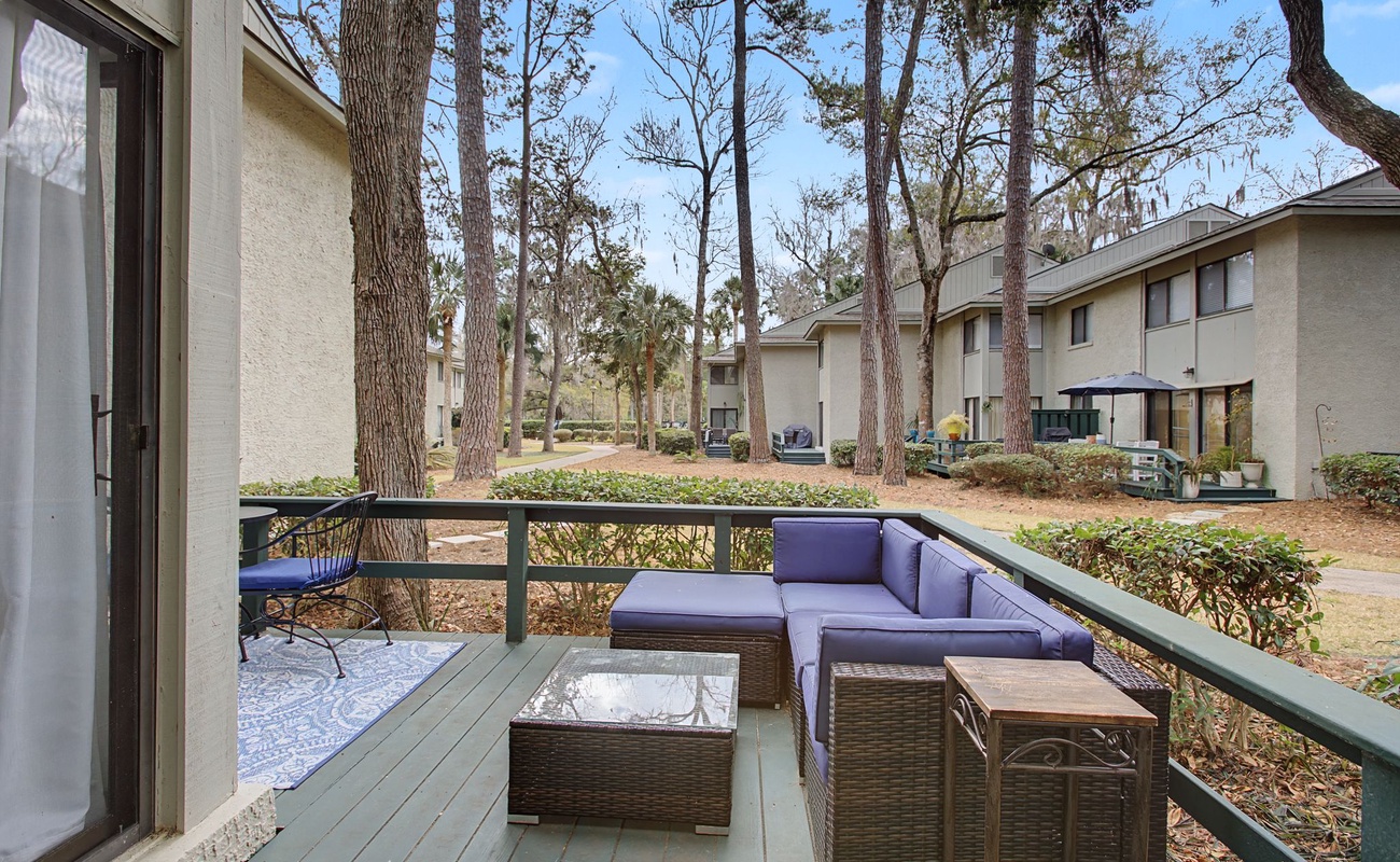 Unwind on your private deck with plush seating overlooking peaceful wooded grounds—your perfect spot for morning coffee or evening relaxation.