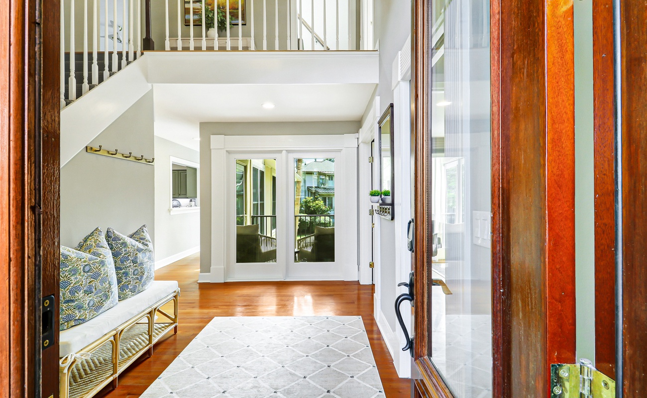 Bright, welcoming entryway with gleaming hardwood floors and cozy seating nook perfect for planning daily adventures.