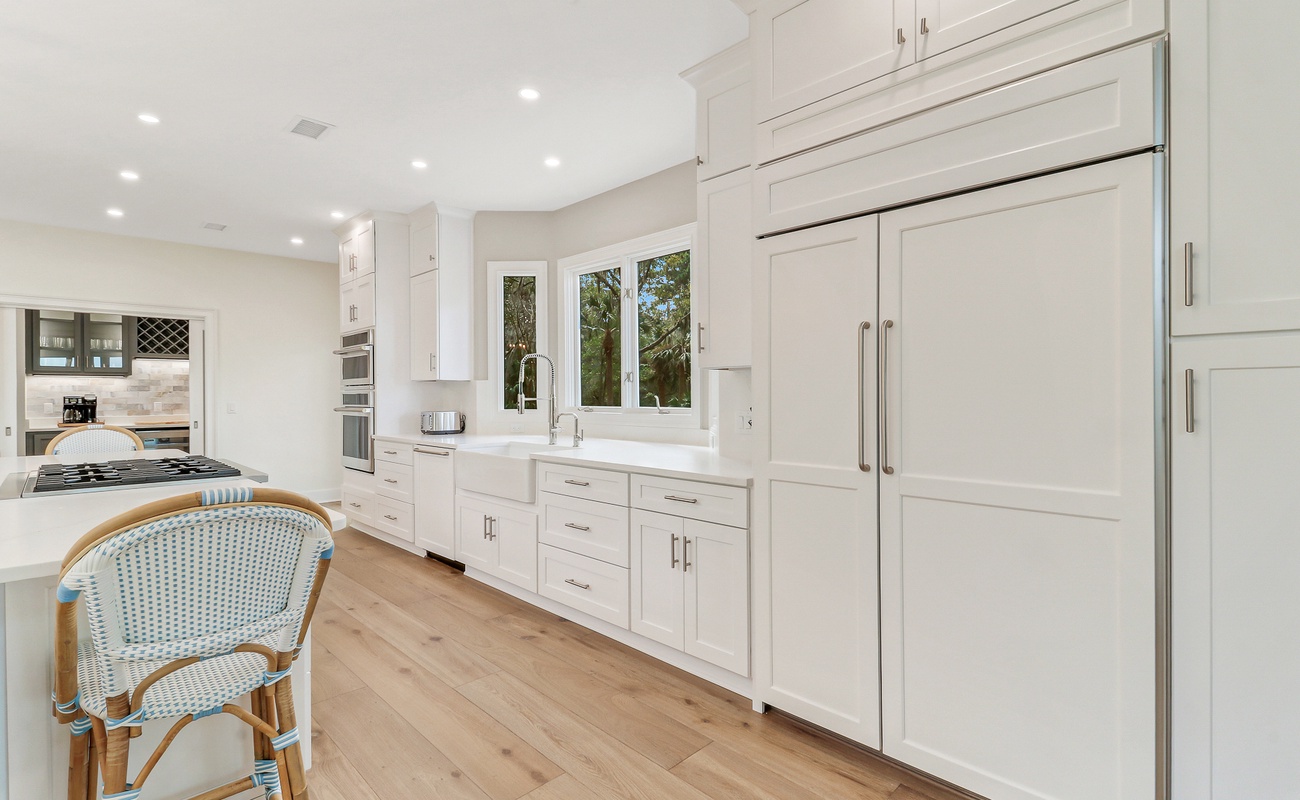Cook with ease in this bright, modern kitchen featuring premium appliances and elegant white cabinetry.