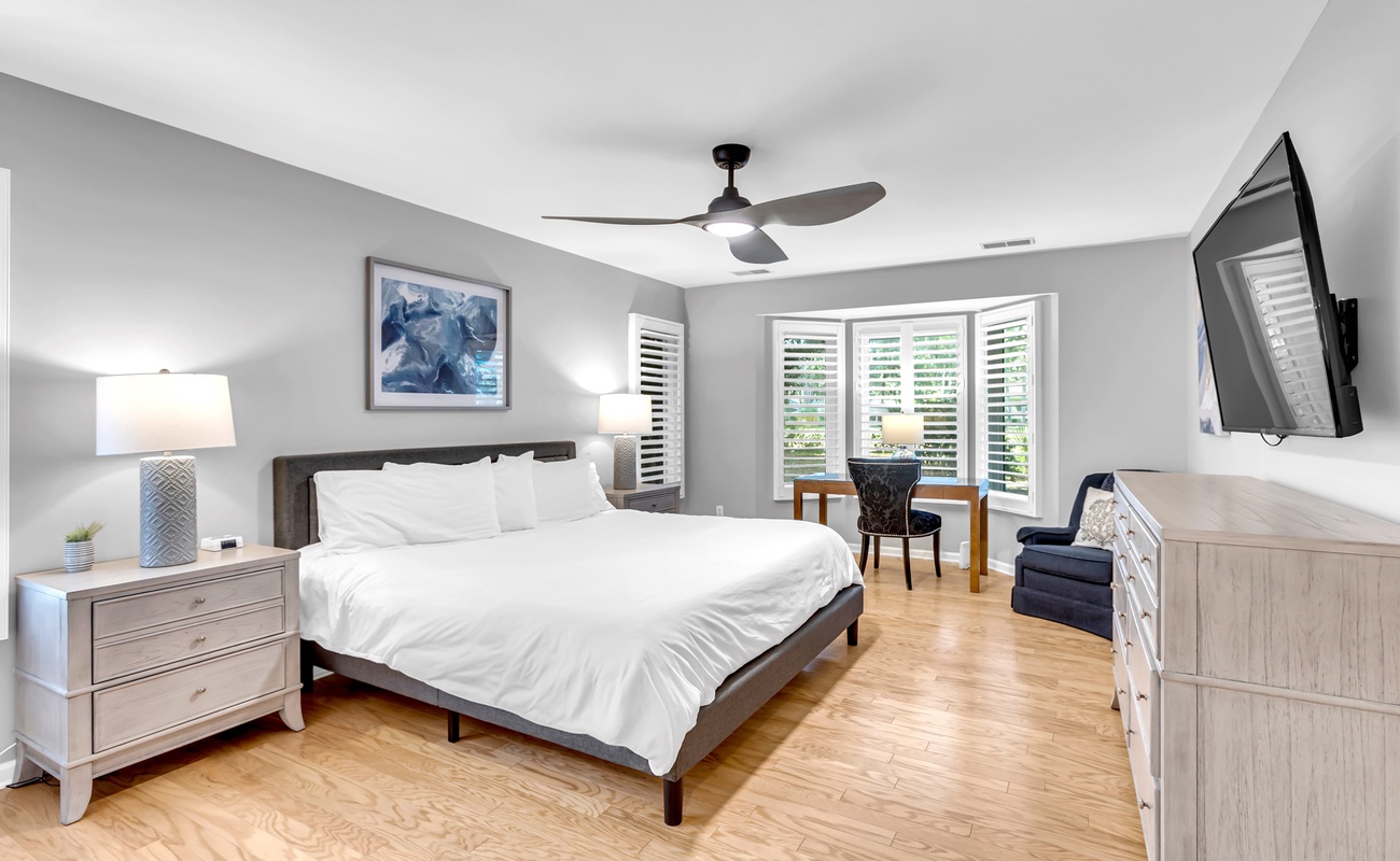 Slip into crisp linens and enjoy your modern sanctuary with hardwood floors, ceiling fan, and entertainment center for restful nights.
