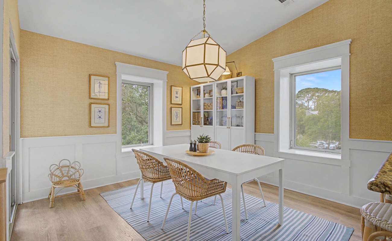 Gather around your elegant dining table where warm golden tones and natural light create the perfect setting for memorable meals.