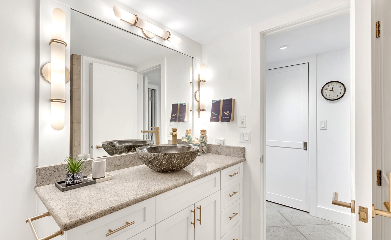 Pamper yourself in this stunning bathroom featuring elegant vessel sinks, warm lighting, and luxurious finishes for your ultimate comfort.
