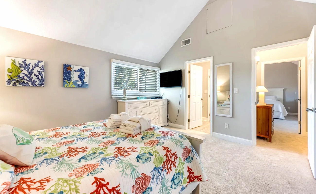 Drift into peaceful sleep on your colorful coral-themed bedding while enjoying the vaulted ceilings and tropical artwork adorning your private retreat.