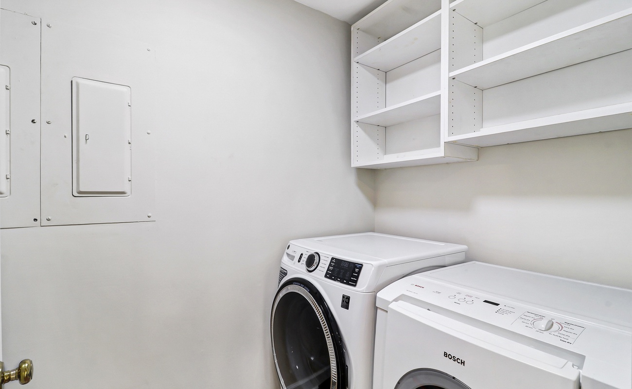 Your private laundry room keeps clothes fresh throughout your stay, with built-in shelving for storage convenience.