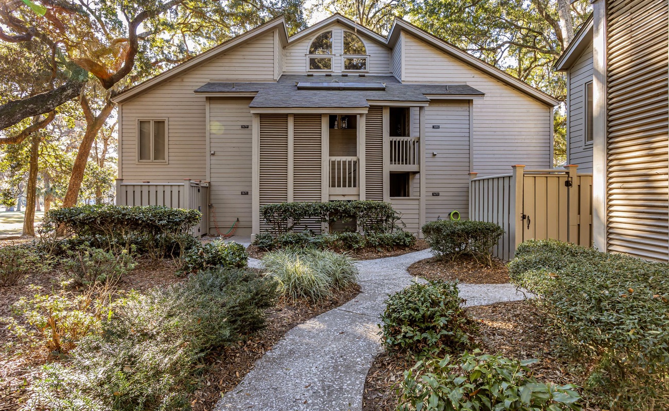Charming vacation townhome nestled among mature trees with private entrance and landscaped gardens welcoming your arrival.