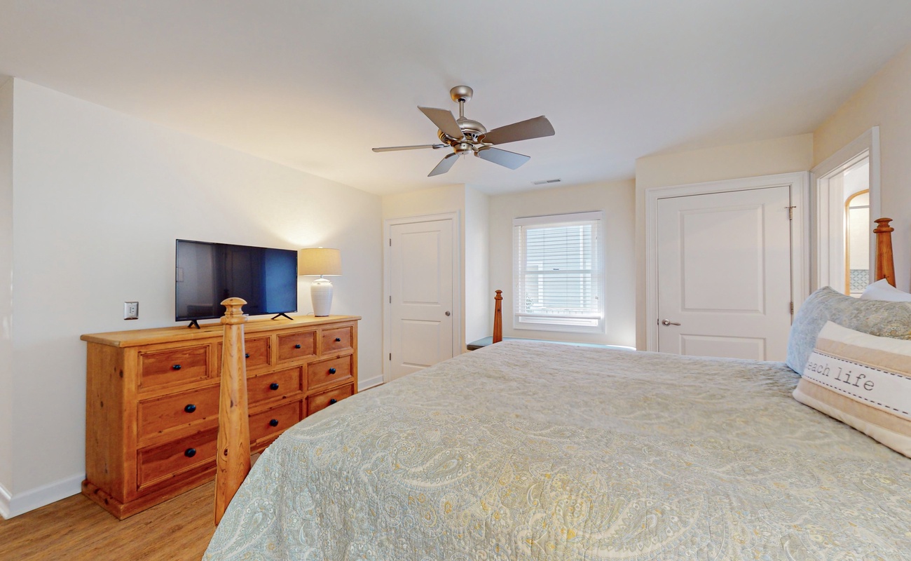 Wake up refreshed in your serene bedroom with comfortable bedding, ample storage, and gentle ceiling fan for perfect temperature control.