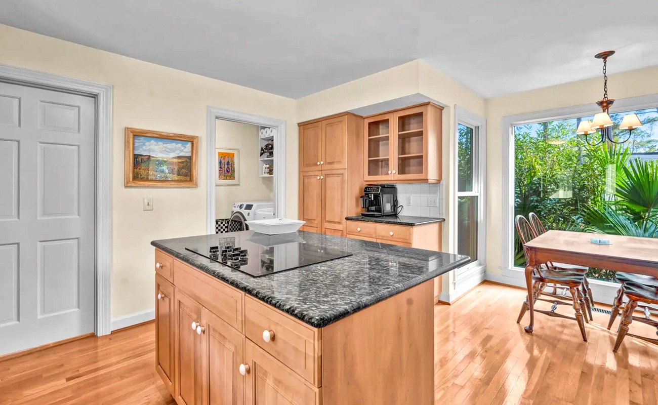 Prepare your favorite meals in this bright, fully-equipped kitchen with granite countertops, modern appliances, and garden views.