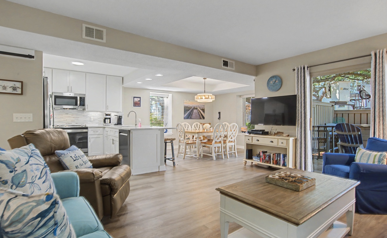 Relax in your open-concept haven where coastal blues meet warm neutrals, creating the perfect flow from kitchen to living space.