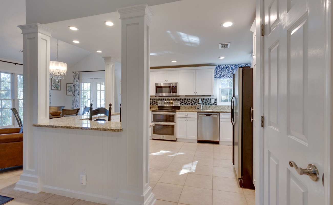 Step into your spacious kitchen with granite countertops, stainless appliances, and bright natural light streaming through large windows.