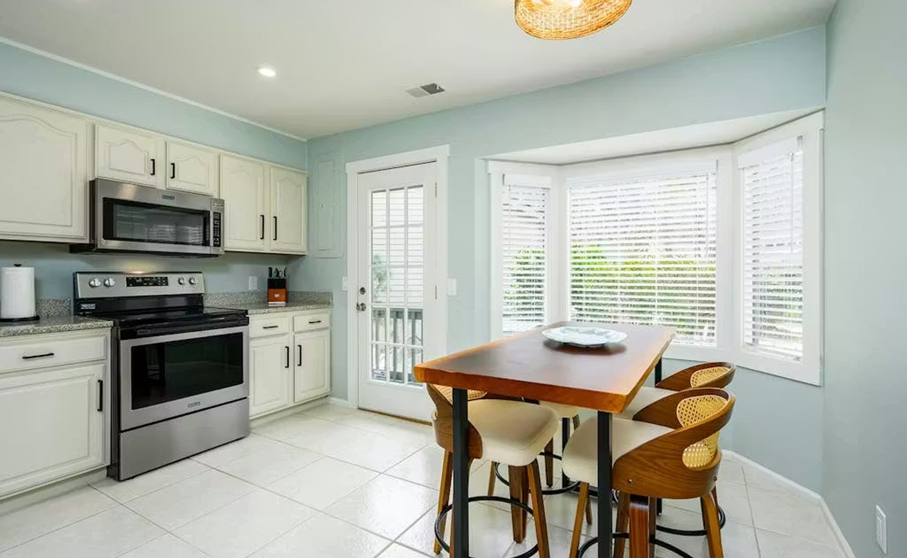 Your bright kitchen features modern appliances and a dining nook where you can enjoy meals bathed in natural light.