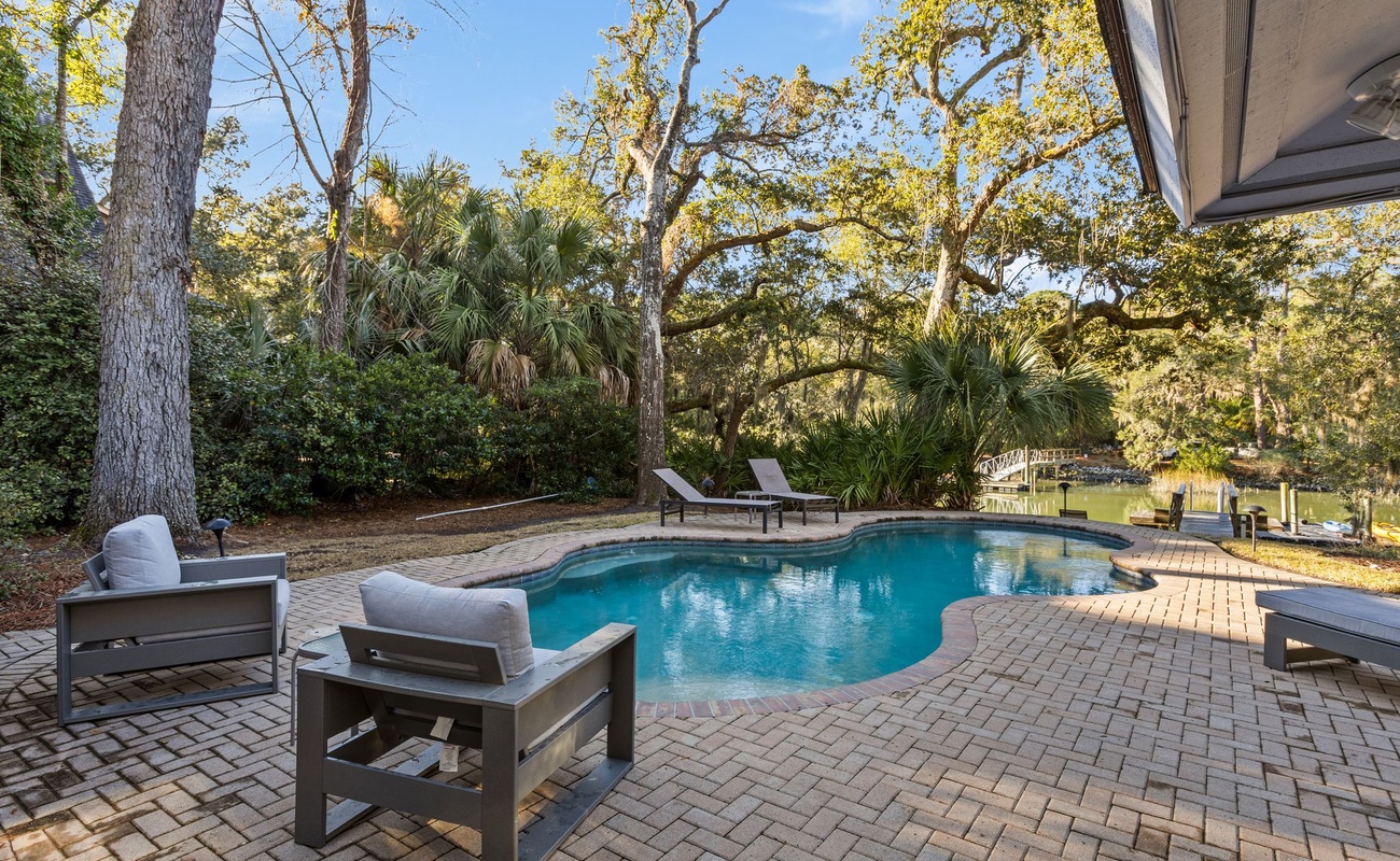 Dive into your private oasis surrounded by towering oaks and palms. Lounge poolside on comfortable chairs while enjoying the peaceful waterfront setting.