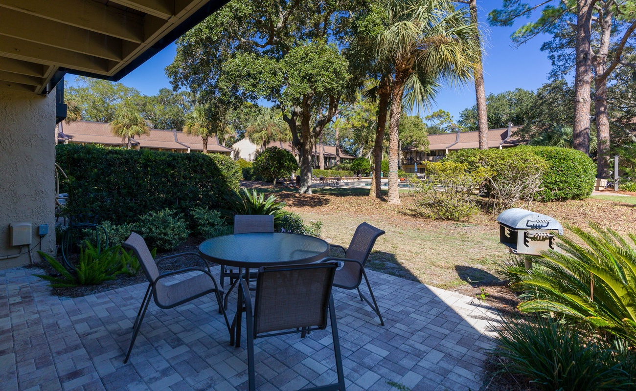 Your private patio offers peaceful dining surrounded by lush tropical landscaping, complete with BBQ grill for memorable outdoor meals.