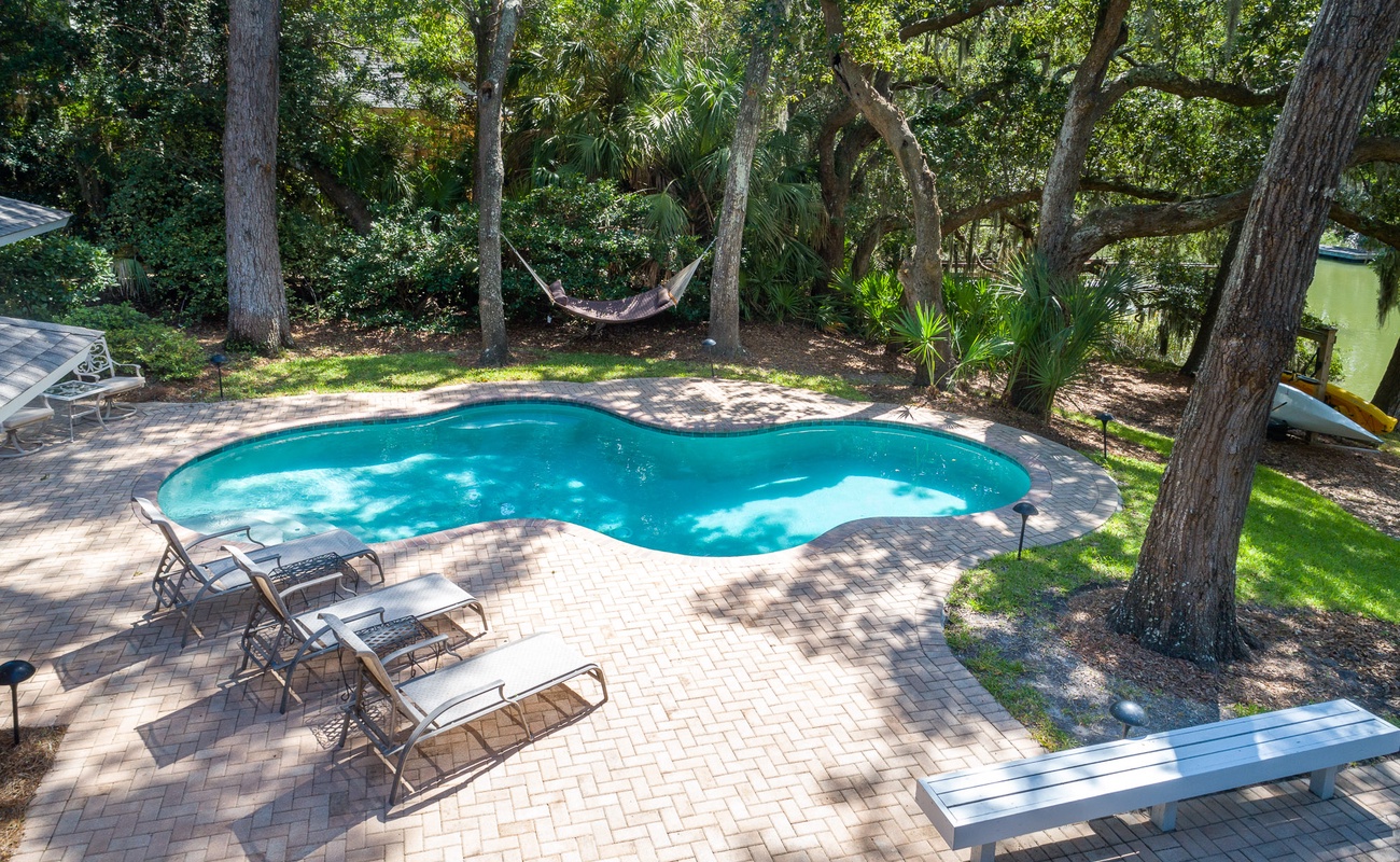 Dive into your private tropical oasis where crystal-clear waters shimmer beneath swaying palms, and that hammock beckons for afternoon relaxation.