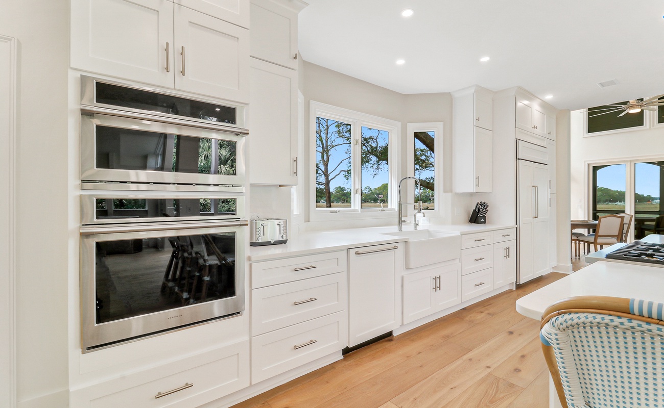 Cook with ease in your gourmet kitchen featuring premium appliances, abundant storage, and bright natural light streaming through garden windows.