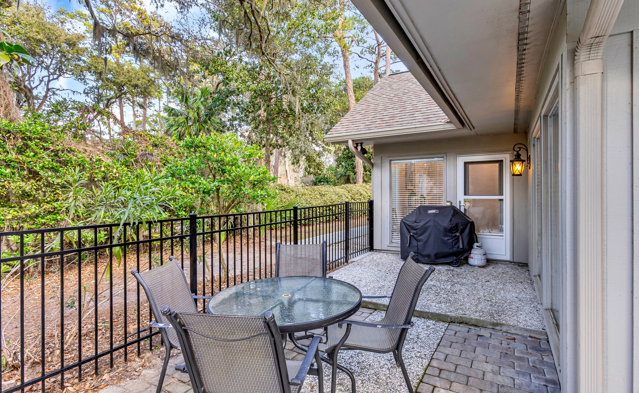 Your private patio invites relaxation with comfortable seating overlooking lush natural surroundings and your personal BBQ setup.