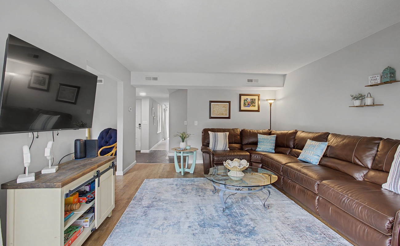 Sink into luxurious leather seating while enjoying your favorite shows on the wall-mounted TV in this thoughtfully designed living space.