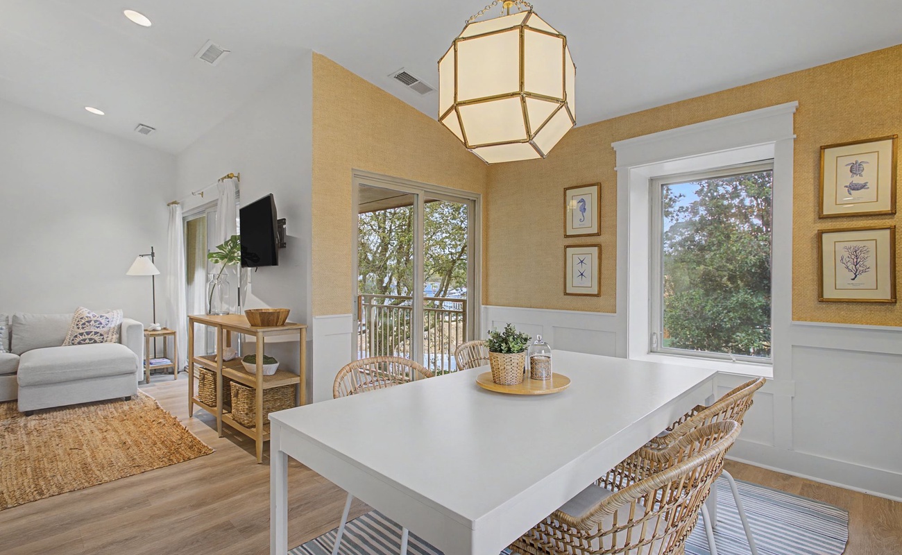 Gather around your bright dining table where natural light streams through windows, creating the perfect spot for morning coffee and shared meals.