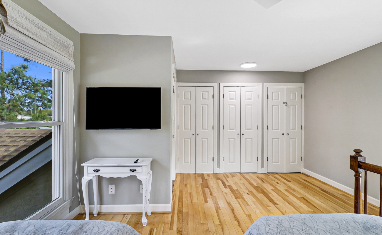 Relax in your serene bedroom with warm hardwood floors, wall-mounted TV, and plenty of closet space for all your belongings.