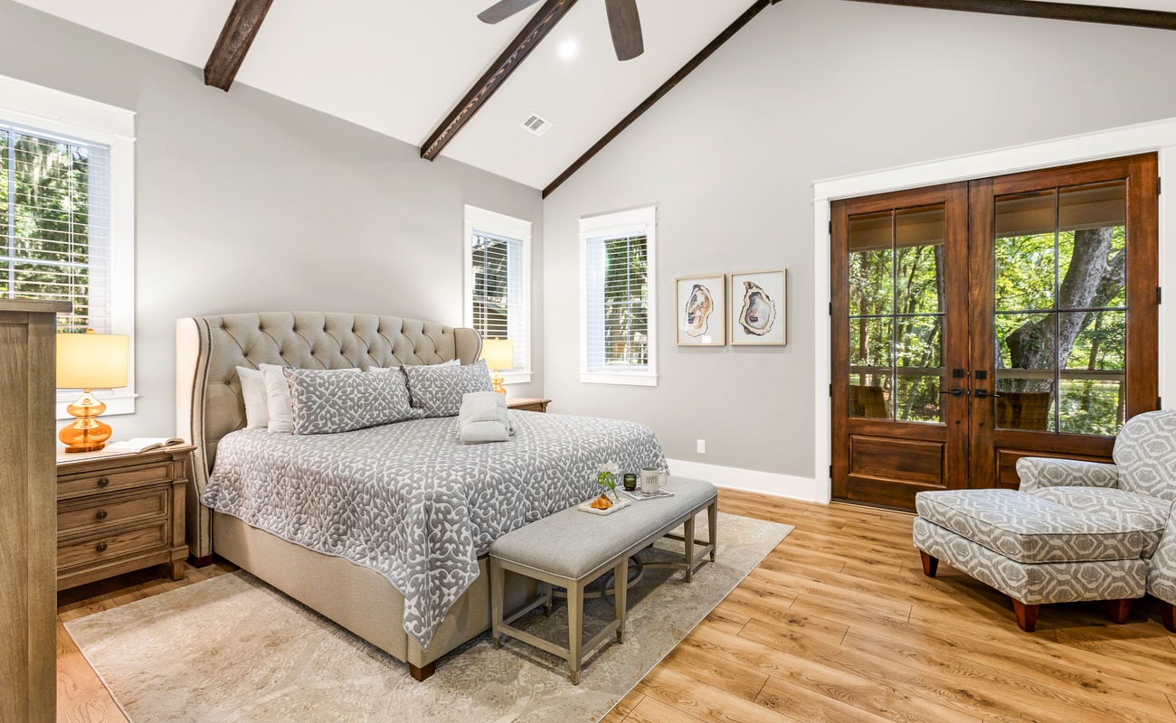 Primary Suite on First Floor with King Bed, En-Suite Bathroom, and Access to Wraparound Porch