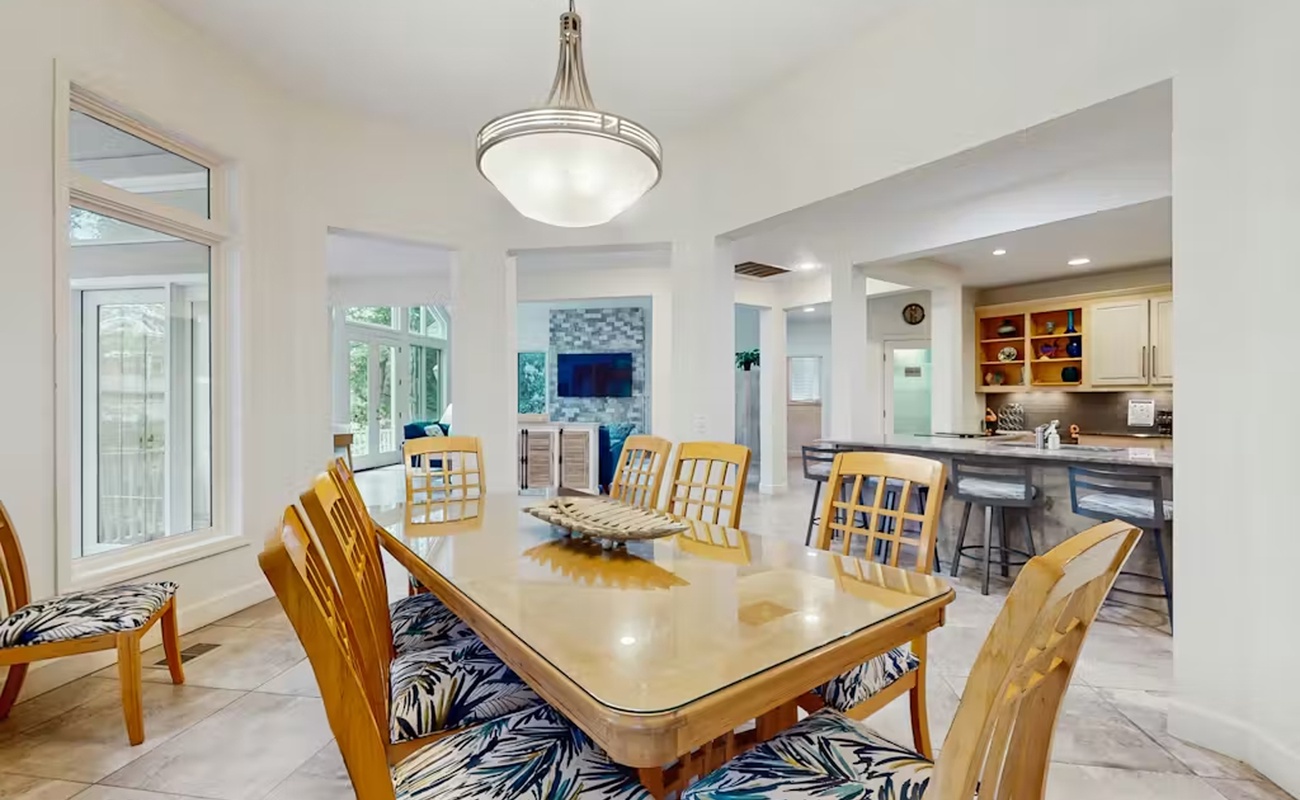 Gather around your spacious dining table for memorable meals while natural light streams through oversized windows and the modern kitchen awaits.