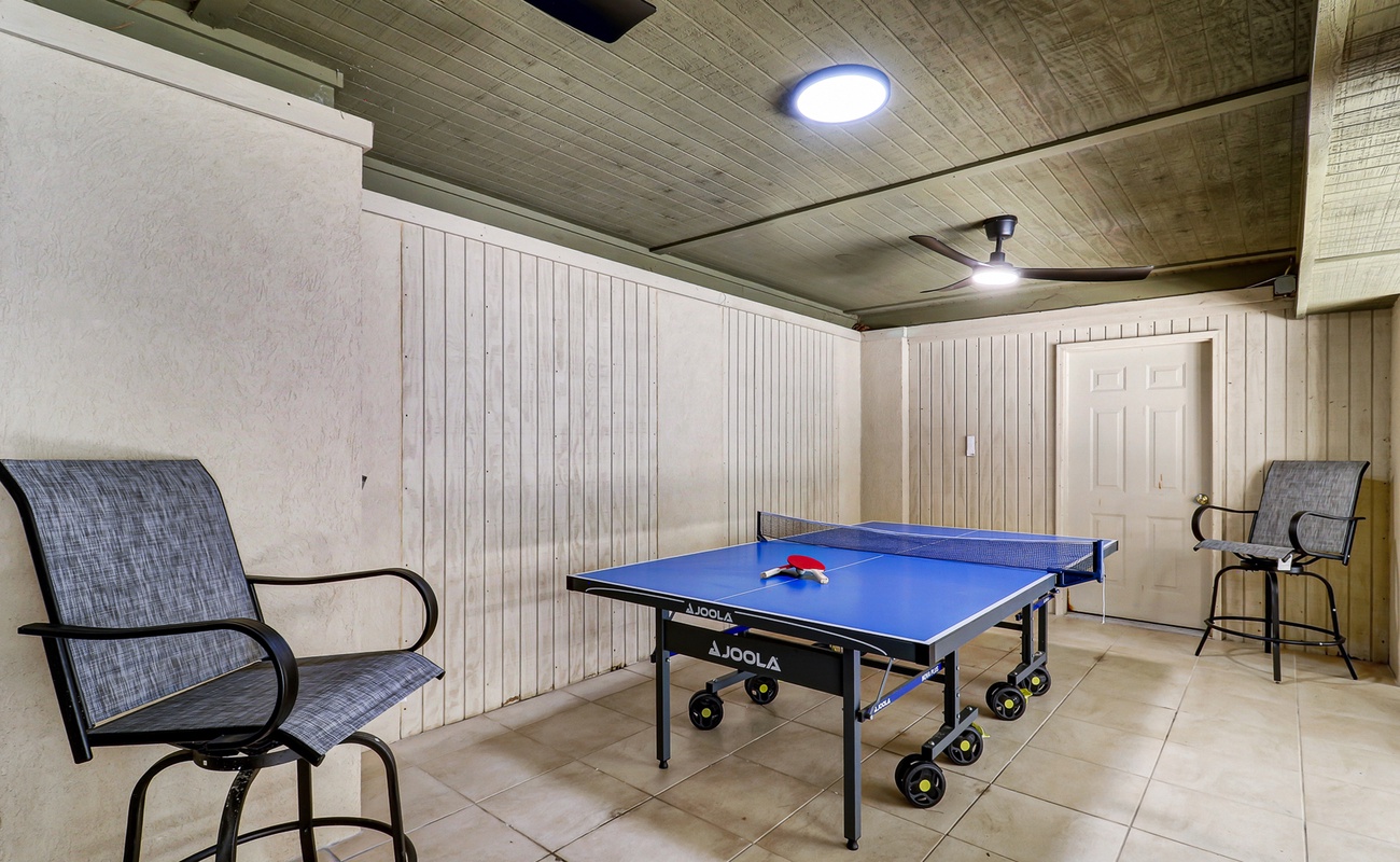 Challenge friends to exciting matches in your private game room, complete with professional table tennis setup and comfortable seating.