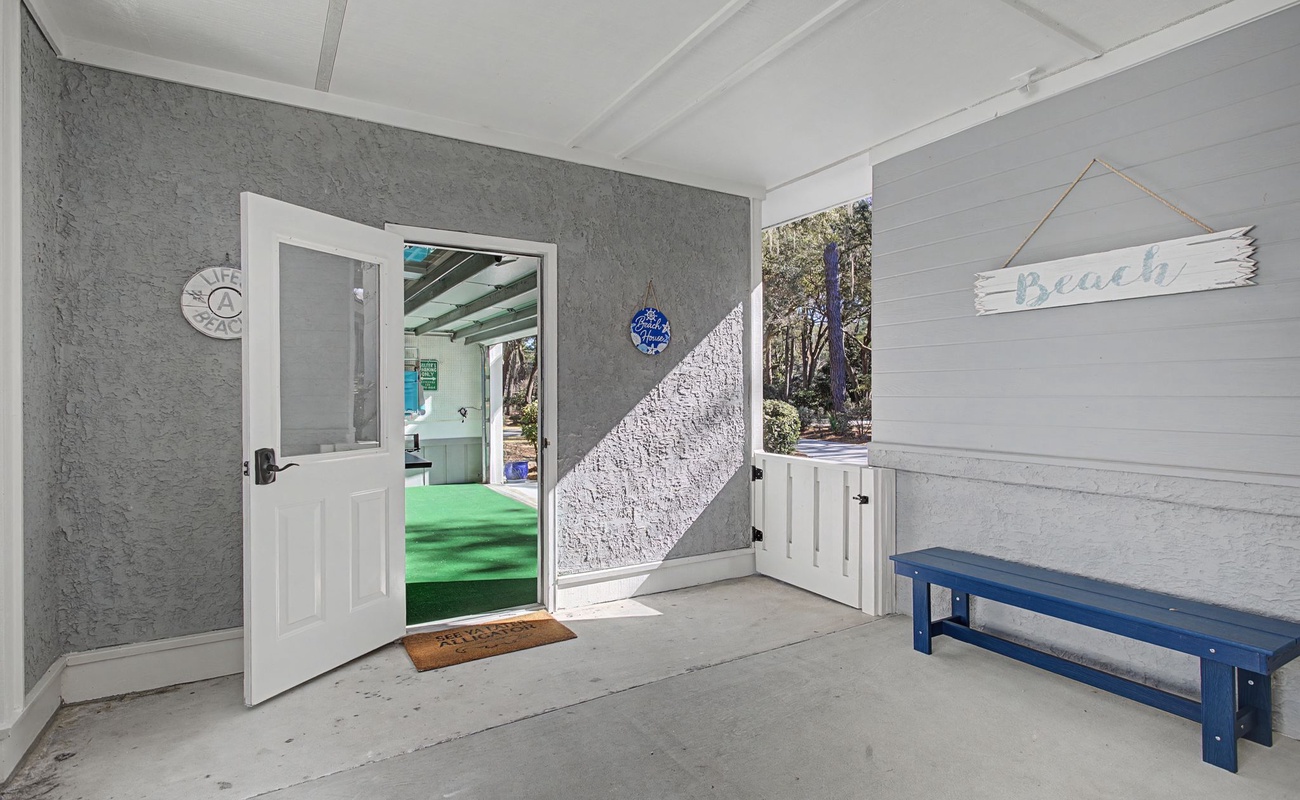 A covered breezeway connects the home to the garage turned game room