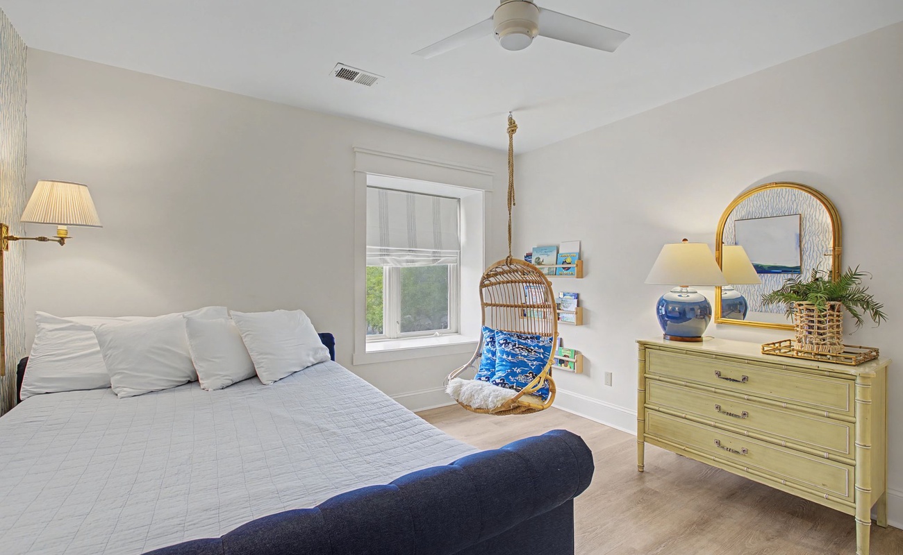 Unwind in your serene bedroom featuring a cozy reading nook and charming coastal touches that create the perfect retreat.