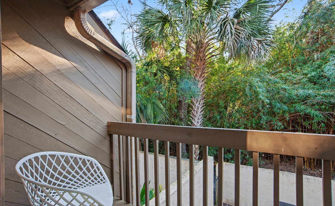 Step onto your private balcony where morning coffee tastes better surrounded by tropical palm trees and lush greenery.