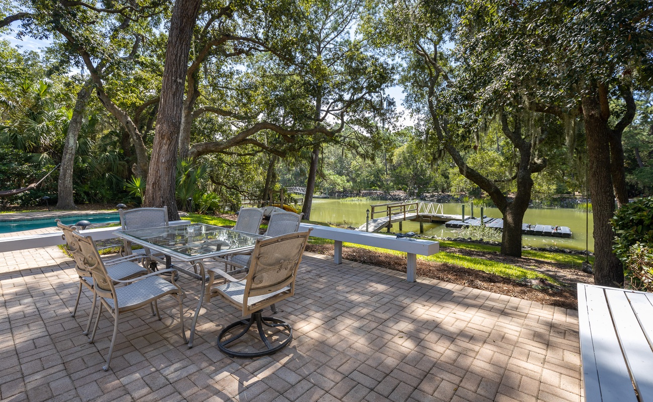 Relax at your private waterfront patio with dining space, overlooking the peaceful canal and dock—your perfect outdoor retreat.