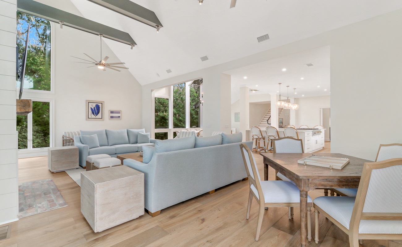 Relax in your spacious living area with soaring ceilings, modern furnishings, and abundant natural light streaming through floor-to-ceiling windows.