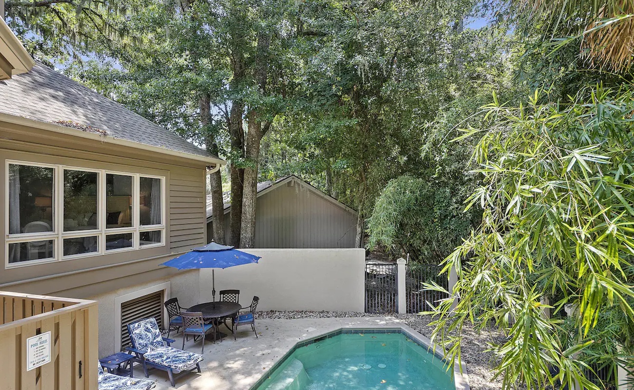 Your private pool awaits with comfortable loungers and dining space under tropical palms for perfect afternoon relaxation.