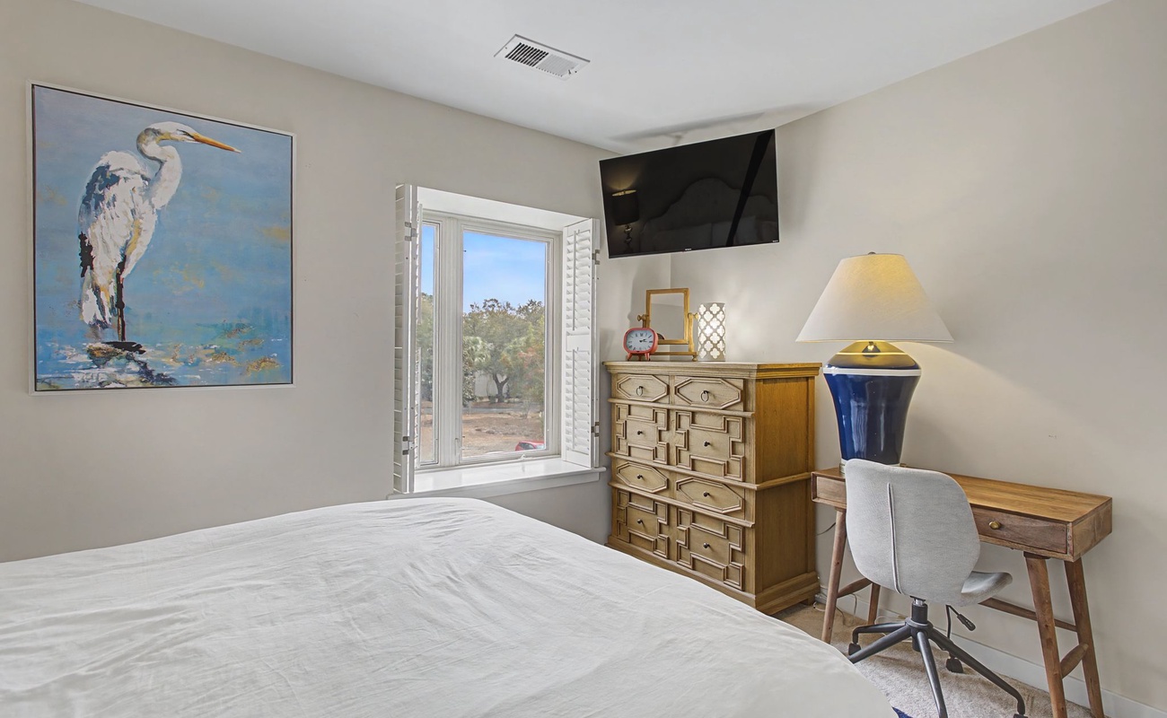 Unwind in your peaceful bedroom featuring coastal artwork, ample storage, and a dedicated workspace for catching up on emails or planning adventures.