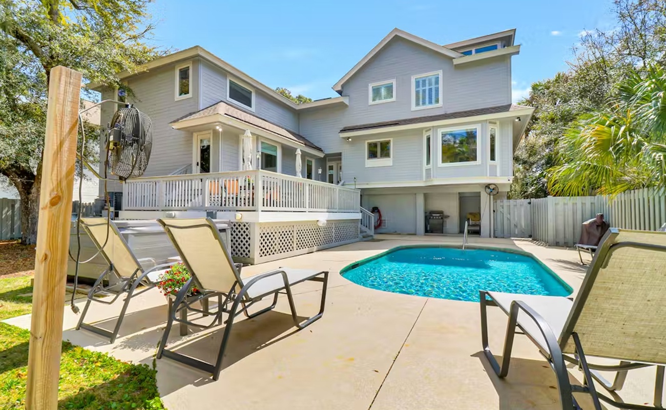 Dive into your private oasis with crystal-clear pool waters surrounded by comfortable loungers and tropical palms.