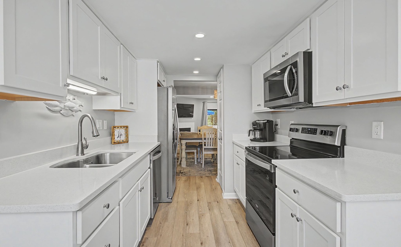 Your bright galley kitchen offers everything you need with modern appliances, ample counter space, and warm wood floors for culinary adventures.