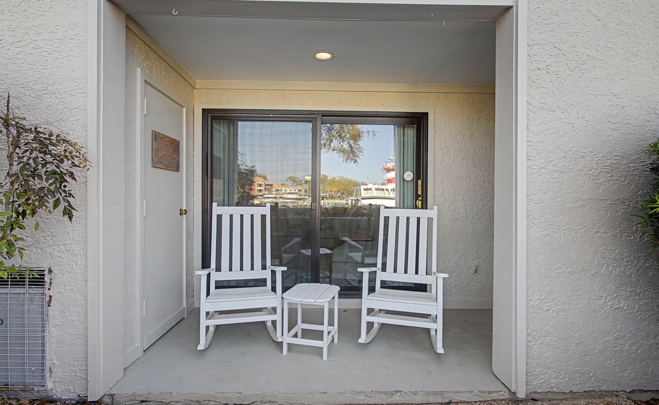 Your private patio retreat awaits with cozy rocking chairs where you can unwind while enjoying peaceful views.