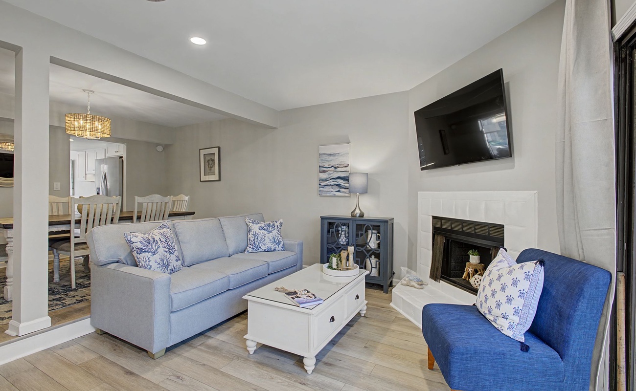 Unwind in your elegant living space with coastal-inspired blues, a cozy fireplace, and open layout perfect for relaxing after your adventures.