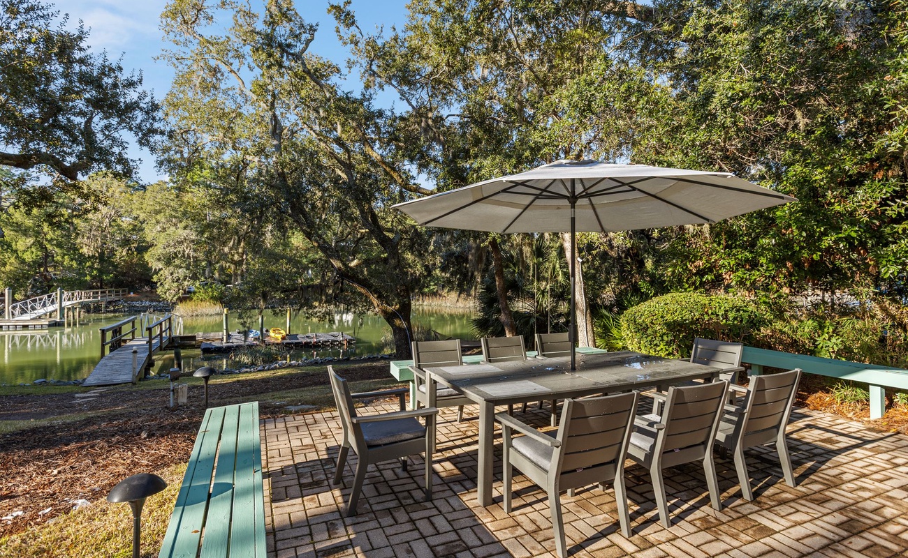 Waterfront dining with private dock access surrounded by mature trees and peaceful lake views.