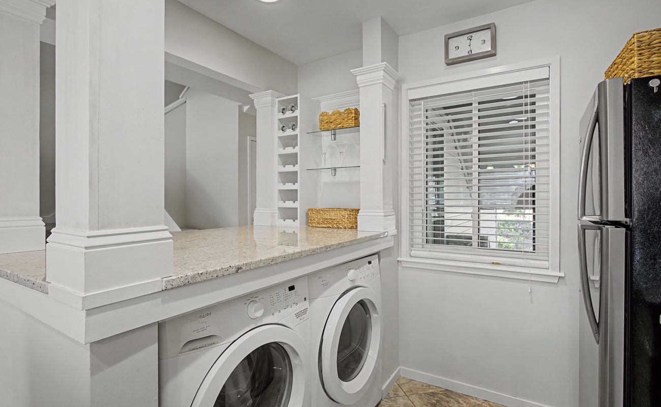 Your laundry day just got luxurious with this bright, organized space featuring modern appliances and ample storage.
