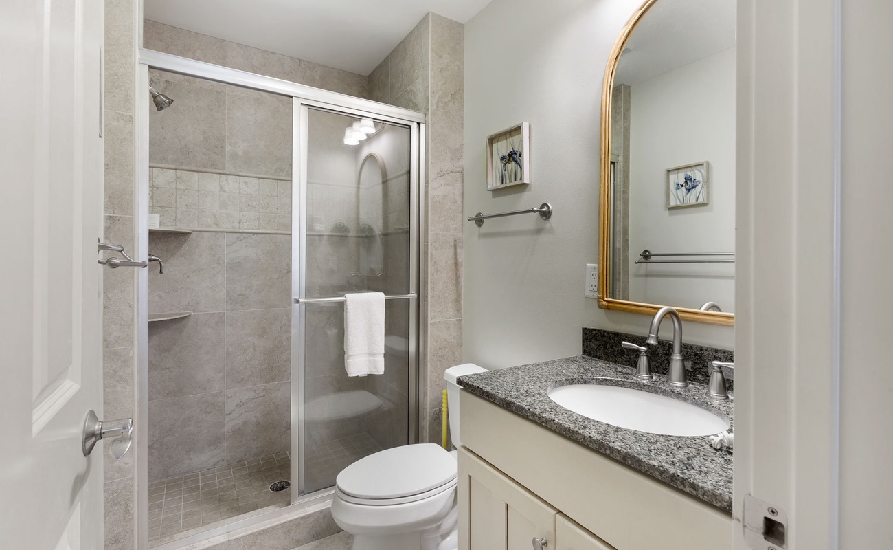 Step into your private bathroom sanctuary with elegant granite countertops, spacious walk-in shower, and thoughtful touches.