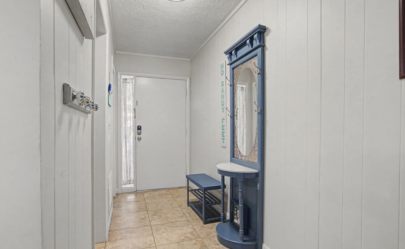 Step into your welcoming entryway, where warm touches like the charming blue hall tree create a cozy first impression.