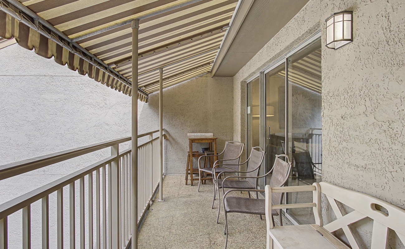 Unwind on your private covered balcony with comfortable seating and peaceful atmosphere.