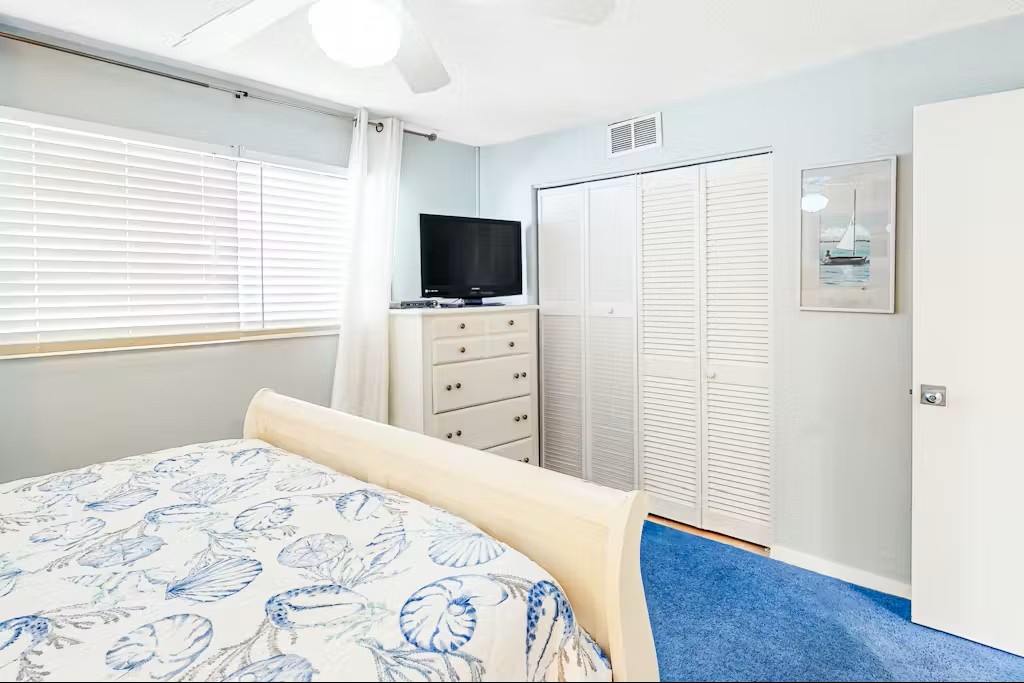 Relax in your bright bedroom with coastal-inspired decor, flat-screen TV, and ample storage for your seaside getaway.